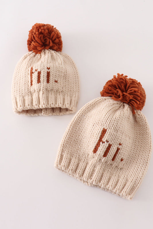 Beige pompom hi cable beanie